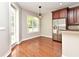 Dining area with a window, hardwood floors, and stainless steel fridge at 1649 Lake Baldwin Ln, Orlando, FL 32814