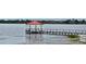 Picturesque lake view featuring a charming dock with a red-roofed gazebo extending into the water at 1649 Lake Baldwin Ln, Orlando, FL 32814