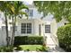 Townhouse exterior with a small yard, palm tree, and a white wall at 1649 Lake Baldwin Ln, Orlando, FL 32814