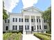 Elegant building with white columns, black shutters, and meticulously maintained landscaping at 1649 Lake Baldwin Ln, Orlando, FL 32814