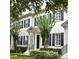 Charming two-story home with a manicured lawn, black shutters and well-maintained landscaping at 1649 Lake Baldwin Ln, Orlando, FL 32814