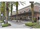 Attractive building exterior featuring palm trees, outdoor seating, and storefronts, creating an inviting atmosphere at 1649 Lake Baldwin Ln, Orlando, FL 32814