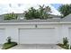 Attached one-car garage of a townhome with a white door and the address number above it at 1649 Lake Baldwin Ln, Orlando, FL 32814