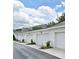 Townhome garages in a row, all with white doors and black carriage lamps above at 1649 Lake Baldwin Ln, Orlando, FL 32814