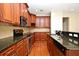 Modern kitchen design with dark countertops, stainless appliances, and wood cabinetry at 1649 Lake Baldwin Ln, Orlando, FL 32814