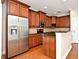 A stylish kitchen with stainless steel appliances, wood cabinets, and a granite countertop at 1649 Lake Baldwin Ln, Orlando, FL 32814