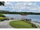 Scenic lake view with a pier, walking path, and lush greenery, ideal for leisure and recreation at 1649 Lake Baldwin Ln, Orlando, FL 32814