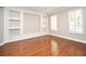 Bright living room with hardwood floors, custom built-ins, and plantation shutters at 1649 Lake Baldwin Ln, Orlando, FL 32814