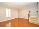 Bright living room featuring hardwood floors, a staircase, and plantation shutters at 1649 Lake Baldwin Ln, Orlando, FL 32814