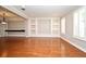 Spacious living room with hardwood floors, custom built-ins, and plantation shutters at 1649 Lake Baldwin Ln, Orlando, FL 32814