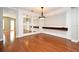 Spacious living room with hardwood floors, decorative mirror, and custom built-ins at 1649 Lake Baldwin Ln, Orlando, FL 32814