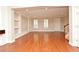 Elegant living room with hardwood floors, built-in shelving, and natural light at 1649 Lake Baldwin Ln, Orlando, FL 32814