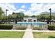 Community pool with a covered lounging area, chairs, and meticulously maintained grounds at 1649 Lake Baldwin Ln, Orlando, FL 32814