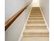 Carpeted staircase with wooden handrail and white walls, leading to the upper level at 1649 Lake Baldwin Ln, Orlando, FL 32814