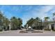 Street with palm trees and a central fountain with meticulously landscaped flower beds at 1649 Lake Baldwin Ln, Orlando, FL 32814