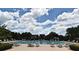 Community swimming pool with lap lanes, sun loungers, and landscaped surroundings at 1649 Lake Baldwin Ln, Orlando, FL 32814