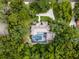 The house is surrounded by plenty of trees providing privacy, a large in-ground pool, and a circular driveway at 1717 Fountainhead Dr, Lake Mary, FL 32746