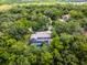 This aerial shot shows a beautiful yard with plenty of trees, a swimming pool, and a spacious driveway at 1717 Fountainhead Dr, Lake Mary, FL 32746