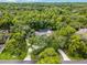A high angle captures this estate enveloped by a dense forest of trees, showcasing a private oasis at 1717 Fountainhead Dr, Lake Mary, FL 32746