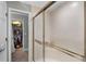 The bathroom has a framed sliding door leading to the adjacent room with a walk in closet at 1717 Fountainhead Dr, Lake Mary, FL 32746