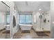 Bright bathroom with a soaking tub, frameless glass shower, and elegant fixtures at 1717 Fountainhead Dr, Lake Mary, FL 32746