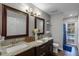 Bathroom features double sinks, granite countertop, and a door leading to the outdoor pool at 1717 Fountainhead Dr, Lake Mary, FL 32746