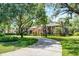 Beautiful brick home featuring a long driveway surrounded by mature landscaping at 1717 Fountainhead Dr, Lake Mary, FL 32746