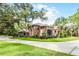 Beautiful brick home featuring a long driveway surrounded by mature landscaping at 1717 Fountainhead Dr, Lake Mary, FL 32746