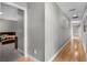 Spacious hallway leads to bedrooms, featuring hardwood flooring and neutral paint at 1717 Fountainhead Dr, Lake Mary, FL 32746
