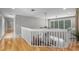 This hallway overlooks the downstairs dining room and has a view to the front yard at 1717 Fountainhead Dr, Lake Mary, FL 32746