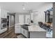 Modern farmhouse kitchen island featuring marble countertops and an open floor plan with wood floors at 1717 Fountainhead Dr, Lake Mary, FL 32746