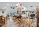 Spacious living room with high ceilings, brick fireplace, pool table, wood floors and access to the pool at 1717 Fountainhead Dr, Lake Mary, FL 32746
