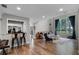 Open living space featuring a bar, a comfortable seating area, and wood floors at 1717 Fountainhead Dr, Lake Mary, FL 32746
