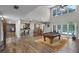 Open-concept living room with a bar, billiard table, and backyard access at 1717 Fountainhead Dr, Lake Mary, FL 32746