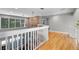 Open loft area boasts hardwood floors, brick accent wall with fireplace, and an abundance of natural light at 1717 Fountainhead Dr, Lake Mary, FL 32746
