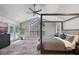 Elegant main bedroom with large window, canopy bed, and access to the outdoor patio at 1717 Fountainhead Dr, Lake Mary, FL 32746