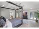 Inviting main bedroom featuring a four-poster bed, TV, and access to the outdoors at 1717 Fountainhead Dr, Lake Mary, FL 32746