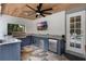 Outdoor kitchen boasts stainless steel appliances, granite countertop and tiled floors at 1717 Fountainhead Dr, Lake Mary, FL 32746