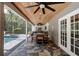 Outdoor kitchen and seating area with wood ceiling and access to the pool at 1717 Fountainhead Dr, Lake Mary, FL 32746