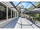 A spacious outdoor patio offers an open-air design with a screened-in area and views of the natural surroundings at 1717 Fountainhead Dr, Lake Mary, FL 32746