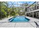 A screened-in pool offers a relaxing spot with an outdoor bar and dining area that's perfect for entertaining at 1717 Fountainhead Dr, Lake Mary, FL 32746