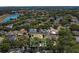 Aerial view highlighting a home, surrounded by trees, in a leafy neighborhood at 1731 Knotting Hill Dr, Orlando, FL 32835