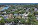 Aerial view of a neighborhood highlighting tree-lined streets and a nearby lake at 1731 Knotting Hill Dr, Orlando, FL 32835