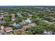 A high aerial view of a neighborhood featuring mature trees, single-Gathering homes, and community amenities at 1731 Knotting Hill Dr, Orlando, FL 32835