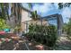 Lush backyard with brick patio, plants, and a screened pool enclosure at 1731 Knotting Hill Dr, Orlando, FL 32835
