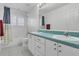 Well-lit bathroom with a dual-sink vanity and a shower-tub combination with white tile at 1731 Knotting Hill Dr, Orlando, FL 32835