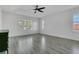 Bright bedroom with new flooring, large windows, and a modern ceiling fan at 1731 Knotting Hill Dr, Orlando, FL 32835