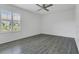 Neutral bedroom with wood-look floors, a ceiling fan, and a window with plantation shutters at 1731 Knotting Hill Dr, Orlando, FL 32835