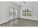Bright bedroom with hardwood floors, access to porch, and plantation shutters at 1731 Knotting Hill Dr, Orlando, FL 32835