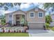 Inviting two-story home featuring a well-maintained yard and charming architectural details at 1731 Knotting Hill Dr, Orlando, FL 32835